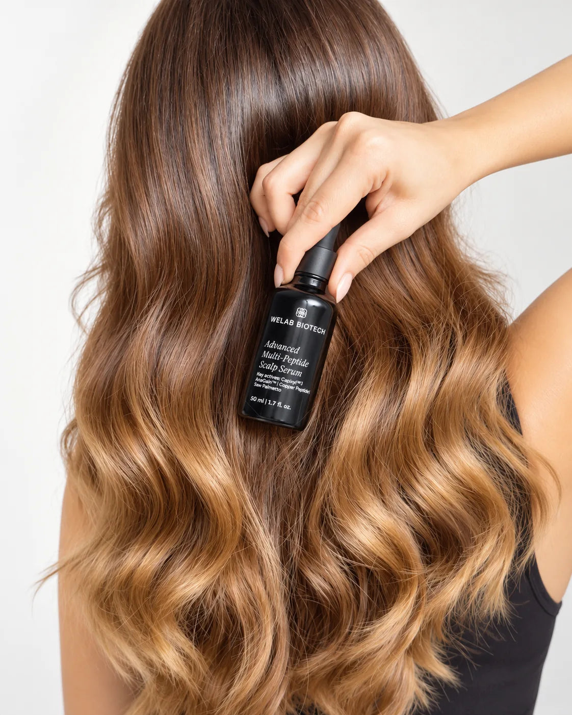 WELAB BIOTECH Advanced Multi-Peptide Scalp Serum held against long healthy-looking hair